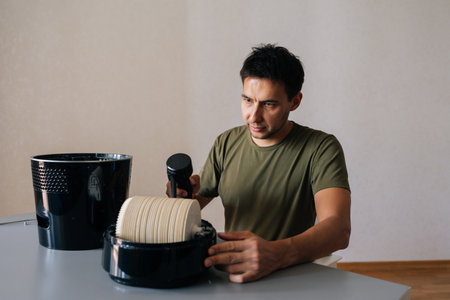 Cleaning service employee carefully maintaining air humidifier filter, ensuring clean indoor air...