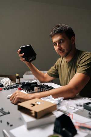 Skilled technician mounting CPU cooler on motherboard, performing precise hardware maintenance...