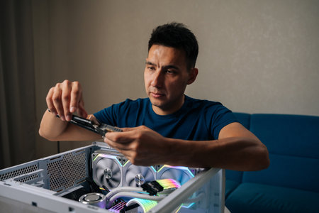 Skilled computer technician inserting wireless network module inside custom desktop computer, enhancing system connectivity for reliable internet performance. Concept of modern technology.の写真素材