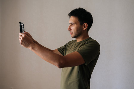 Side view of technician male carefully inspecting and cleaning air humidifier filter, ensuring clean...