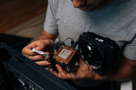 Precise computer maintenance involving cleaning processor cooling system, wiping delicate electronic...