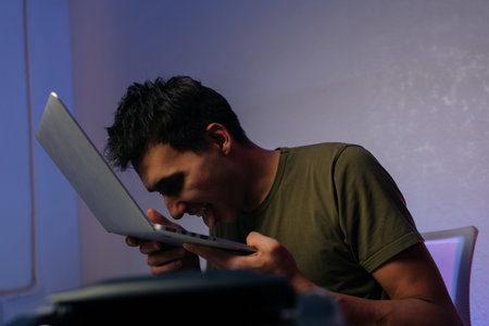 Young programmer male showing extreme frustration after software crash, expressing desperation and...
