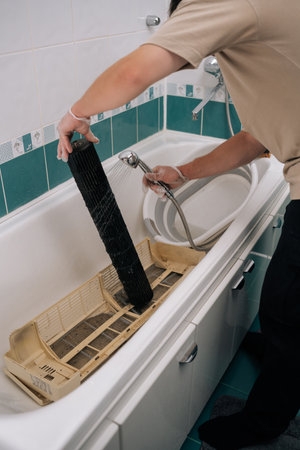 Close-up vertical shot of maintenance worker wearing protective gloves for thorough sanitization...