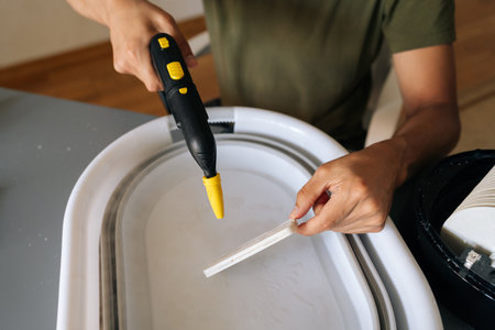 Closeup cropped shot of unrecognizable man using steam cleaner for sanitizing humidifier filter...