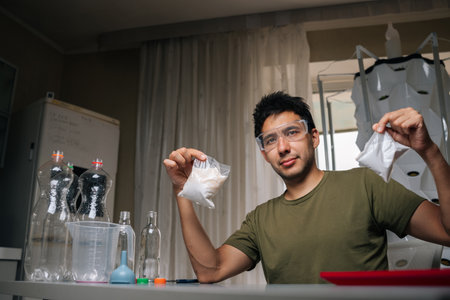 Home gardening enthusiast measuring and mixing nutrients for vertical hydroponic system, ensuring optimal plant growth and yield in controlled environment. Concept of indoor farming.の写真素材
