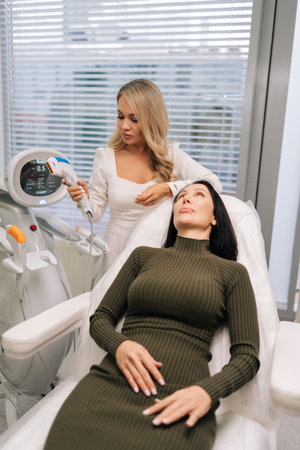 Vertical shot of woman receiving non-invasive ultrasound facial lifting and skin-tightening...
