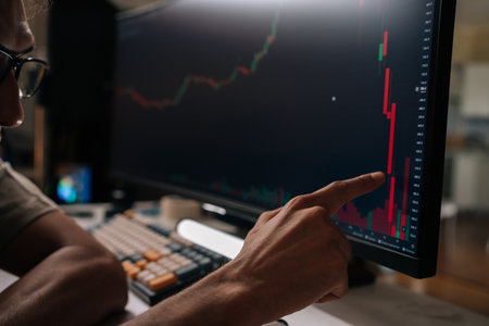 Close-up hands of trader male looking at stock market financial charts on computer screen, analyzing falling prices and market crash data, experiencing business crisis and loss trading online.の写真素材