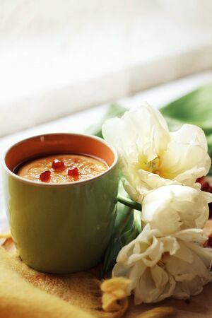 Tender white flower and cup of tea with pomegranateの写真素材
