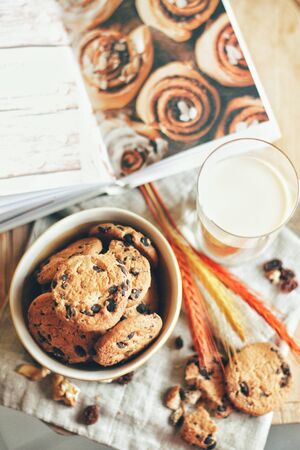 Lunch. Tasty cookies or biscuits with chocolate and milk on the napkin. Feel the home comfort with sweets. Delicious food and drinks concept, healthy eating for morning. Warm colors.の写真素材