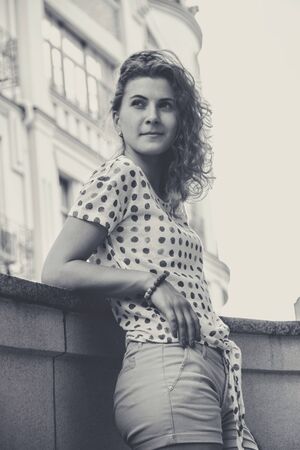 Young pretty girl walking down the street at sunshineの写真素材