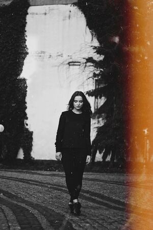 Young pretty girl walking down the street, retro portraitの写真素材