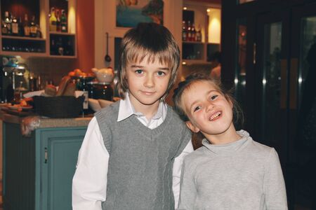 Portrait of little caucasian girl and boy in casual clothes hugging. Cute friends or sister and...