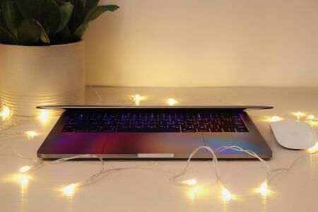 Modern MacBook Laptop computer, Magic Mouse on white in interiorのeditorial素材