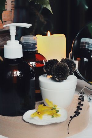 Vanilla. Herbal, alternative medicine, organic essentials for body and face, natural sanitizers at home. Bottles with skin care product and yellow spring flowers. Healthcare, spa, cosmetics concept.の写真素材