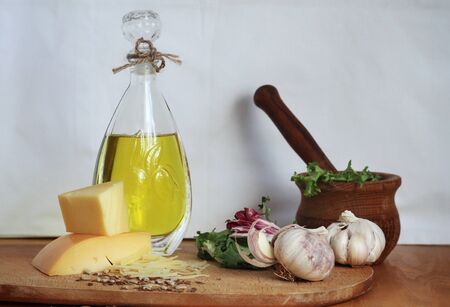 Hand craft. Art composition, design food - oil, garlic, spices and cheese on wooden table and white background. Natural nutrition, organic lifestyle and veganism. Home, crafted cuisine. Modern artworkの写真素材