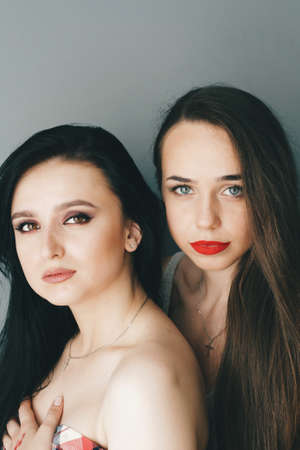 Beautiful young models with bright make-up and long hairの写真素材