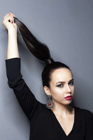 Beautiful young model, longhair girl with bright make-up, red lipsの写真素材