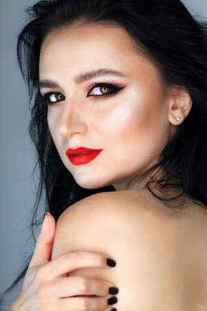 Beautiful young brunette model with bright make-up and long hairの写真素材