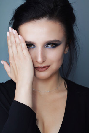 Beautiful young brunette model with bright make-up and long hairの写真素材