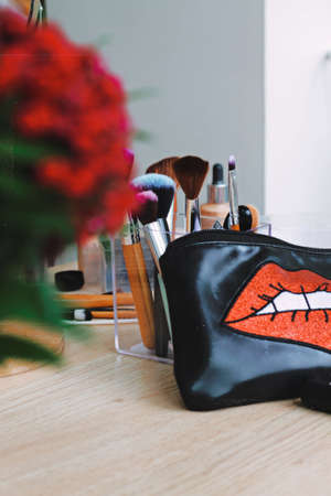 Professional cosmetics set on make up artist work place with flowersの写真素材