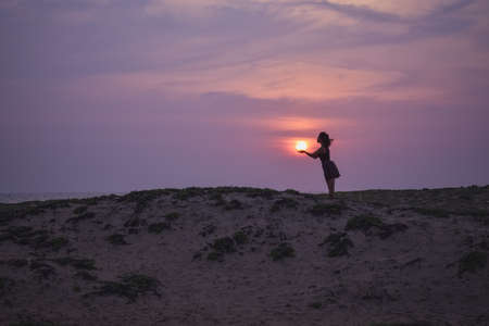 Holding the sunの写真素材