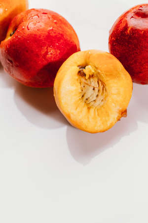 few nectarines on a white mirror background.の写真素材