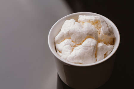 Fresh meringue in light bowl on a dark background.の写真素材