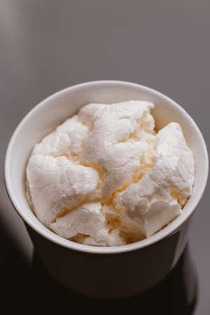 Fresh meringue in light bowl on a dark background.の写真素材