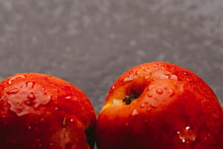few nectarines on a dark mirror background.の写真素材