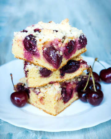 Slices of home made butter cherry cake with crumble toppingの写真素材