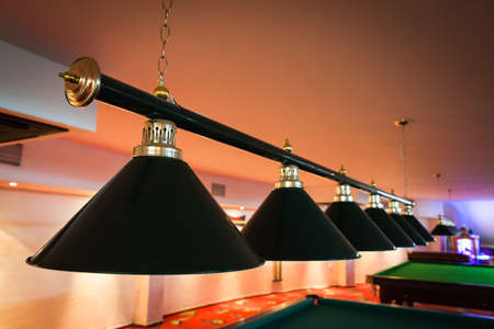Close up of lamps hang over billiard tableの写真素材