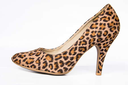 Close up of high heel leopard print female shoe on a white background.の写真素材