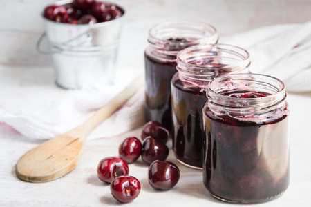 Jars with freshly homemade cherry jamの写真素材