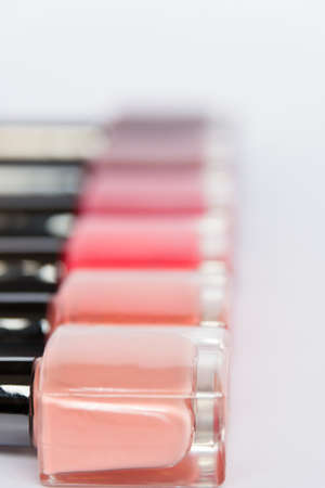 A palette of nail polish bottles on a white backgroundの写真素材