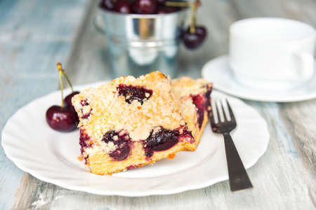 Slices of home made butter cherry cake with crumble toppingの写真素材