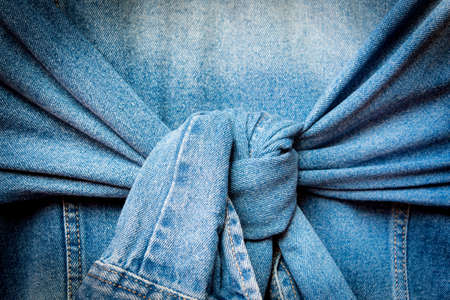 Blue denim jacket with knot tied sleeves