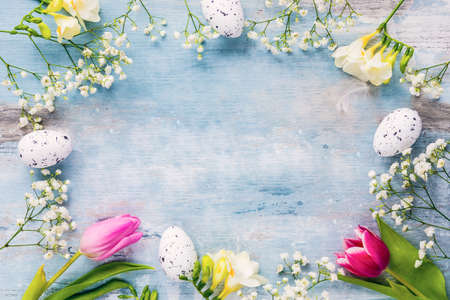 Easter background. A frame of spring flowers and easter eggs. Copy space.の写真素材