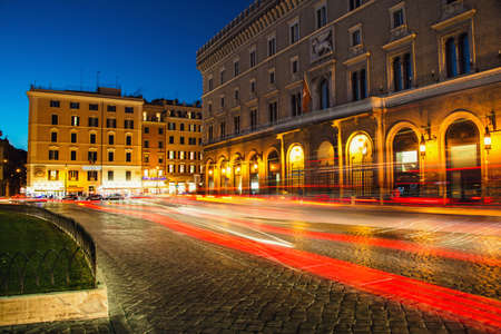 Venezia Palace /Palazzo Venezia/ - the palace of Victor Emmanuel at the Venezia Square /Piazza Venezia/ in Rome, Italy at night. Long exposure, car lights trails effect.のeditorial素材