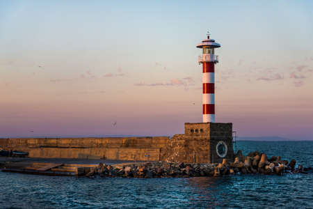Colorful sunset over the lighthouse of the Bourgas sea shore