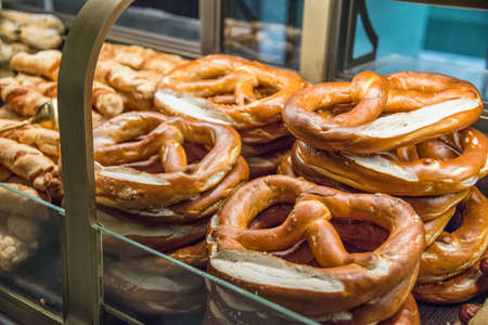Freshly baked pretzels arranged at a shop window.の写真素材