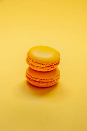 Top view of yellow macaroons over yellow background.の写真素材