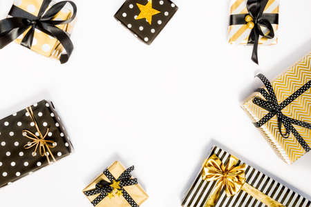 Top view of gift boxes in various black, white and golden designs. Flat lay, copy space. A concept...