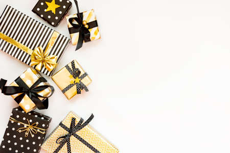 Top view of gift boxes in various black, white and golden designs. Flat lay, copy space. A concept...