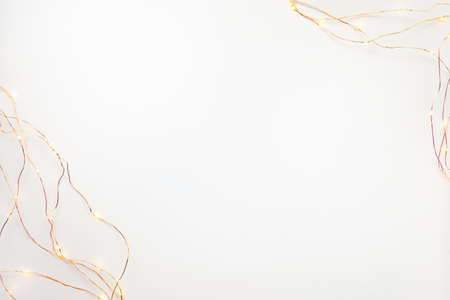 Christmas lights garland border over white background. Flat lay, copy space.の写真素材