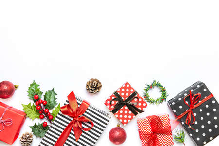 Gift boxes wrapped in striped and dotted black and white and red paper over white background....
