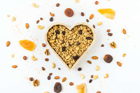 Top view of a heart shaped bow full of crunchy granola. Healthy eating concept.の写真素材