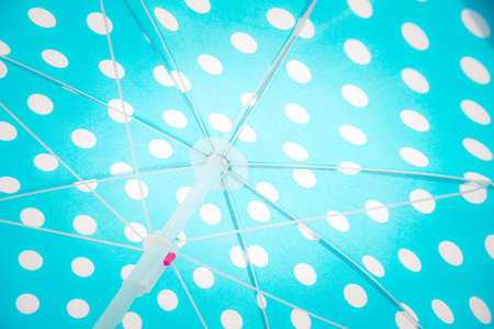 Close upward view of a blue dotted beach umbrella.の写真素材
