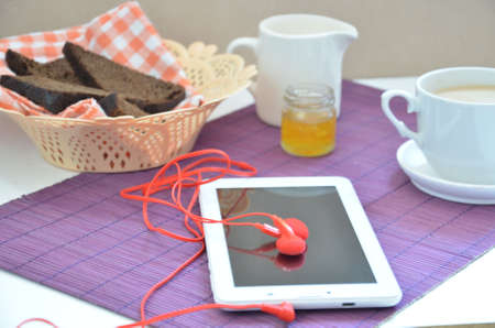 Breakfast on the table cup with tea milkwoman rye bread curds orange jam on a purple napkin white...