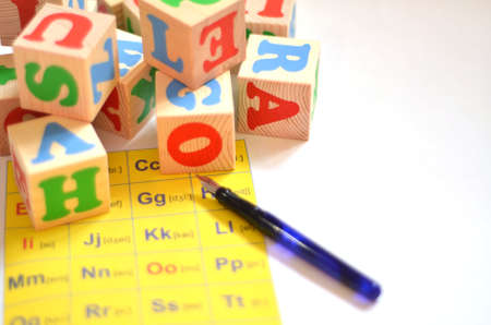 Selective focus of English letters with pen isolate on white background for study English concept. Cubes with lettersの写真素材