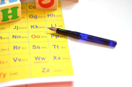 Selective focus of English letters with pen isolate on white background for study English concept. Cubes with lettersの写真素材